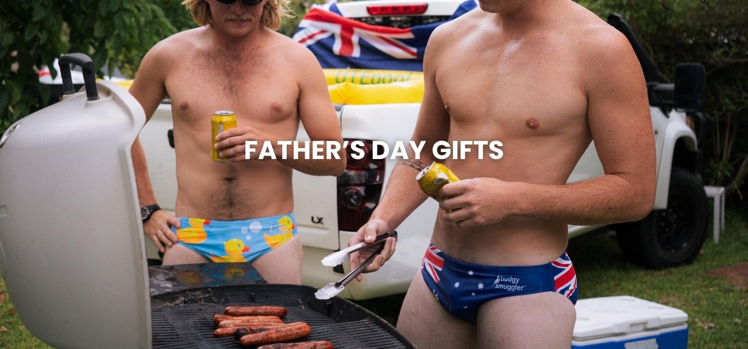 Men in Budgy Smugglers cooking BBQ