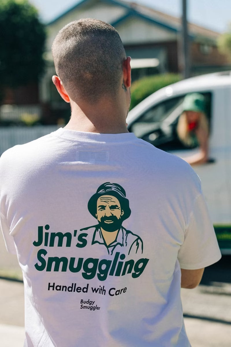 white tee shirt with green detailing on white man with van passing 