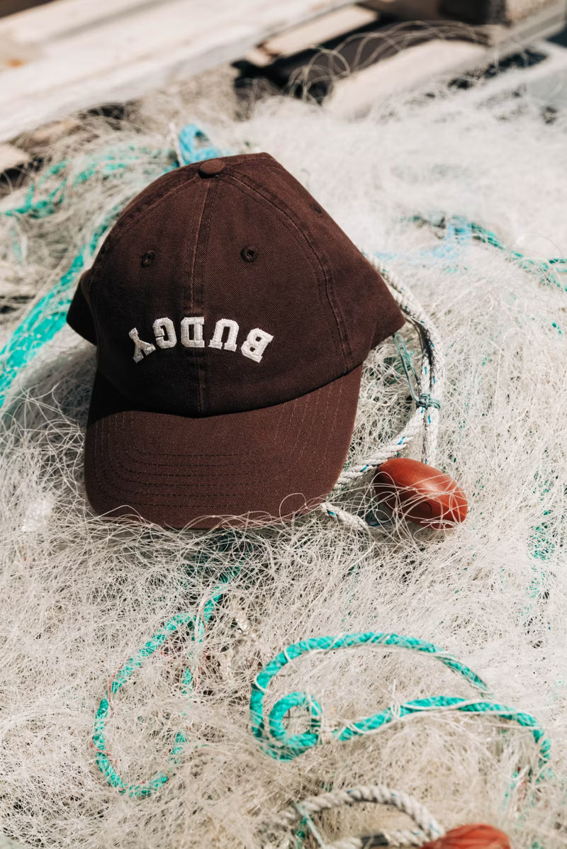Brown cap with white text on a rock 