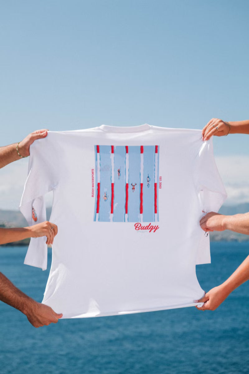 White Tee with swimming pool print help up by hands over water 