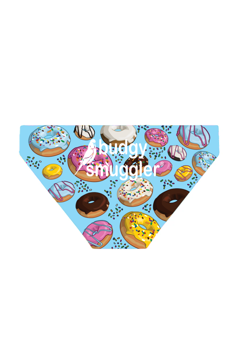 A pair of boys' swimwear briefs with a pattern of colorful donuts on a light blue background, with the text 'buddy smuggler' on the lower right side.