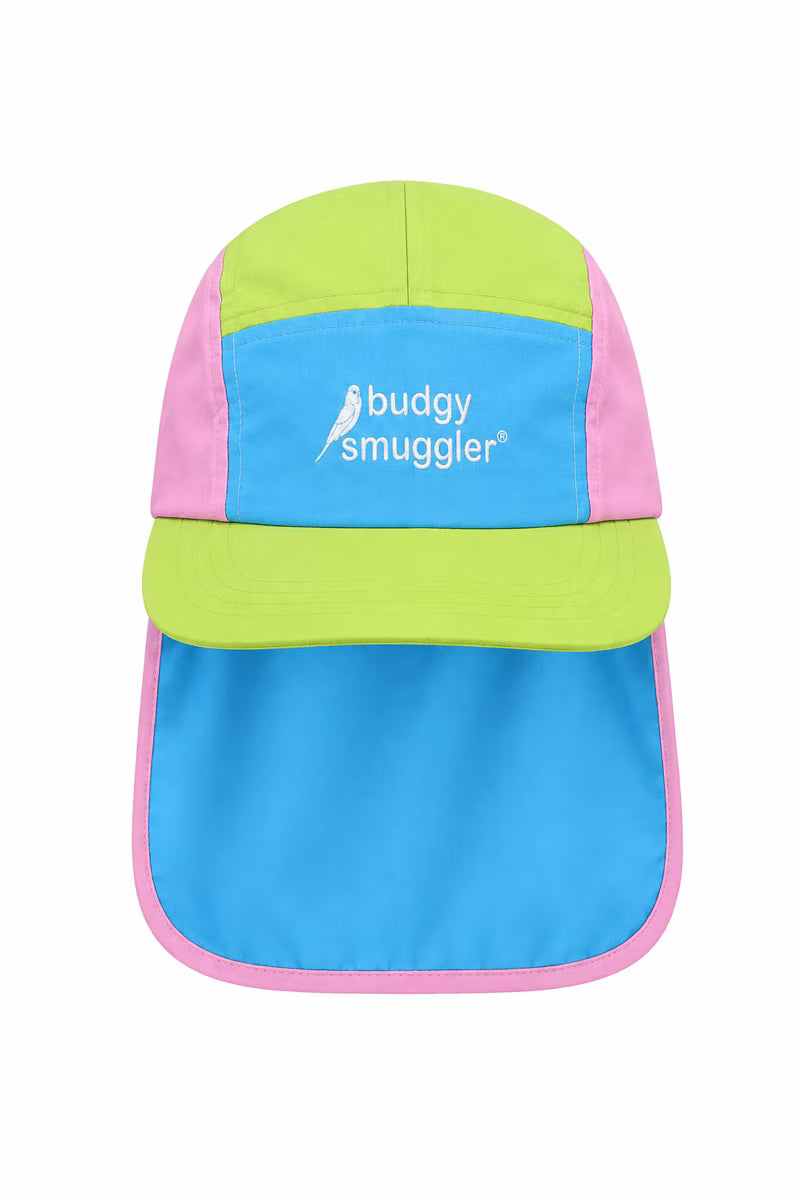 Pink green and blue hat with a neck flap on a white wall 
