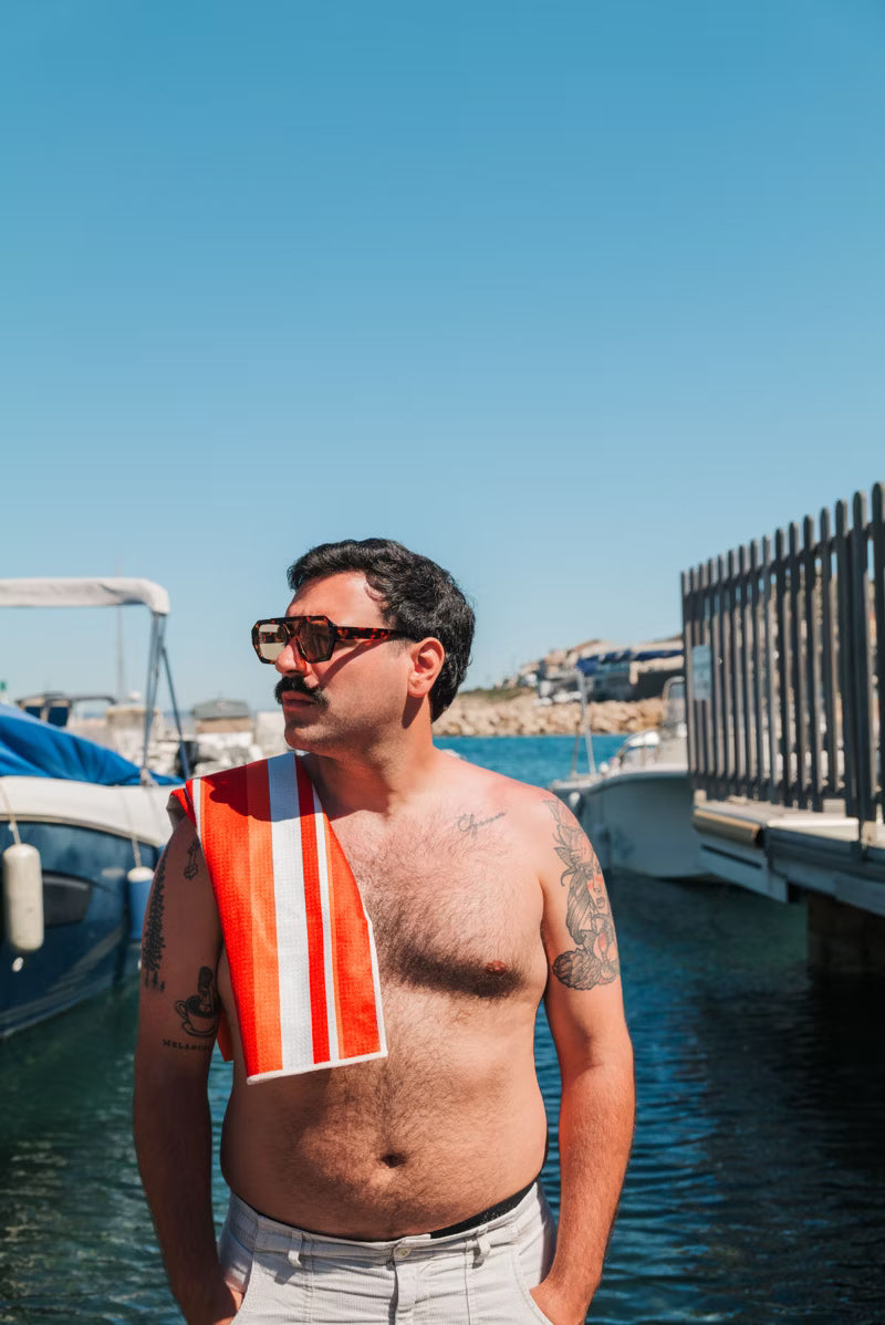 ORANGESTRIPETOWEL over man shoulder 