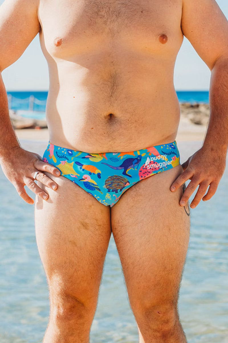 Front view of man in Aussie Battlers budgies, bright aqua with echidnas and platypus