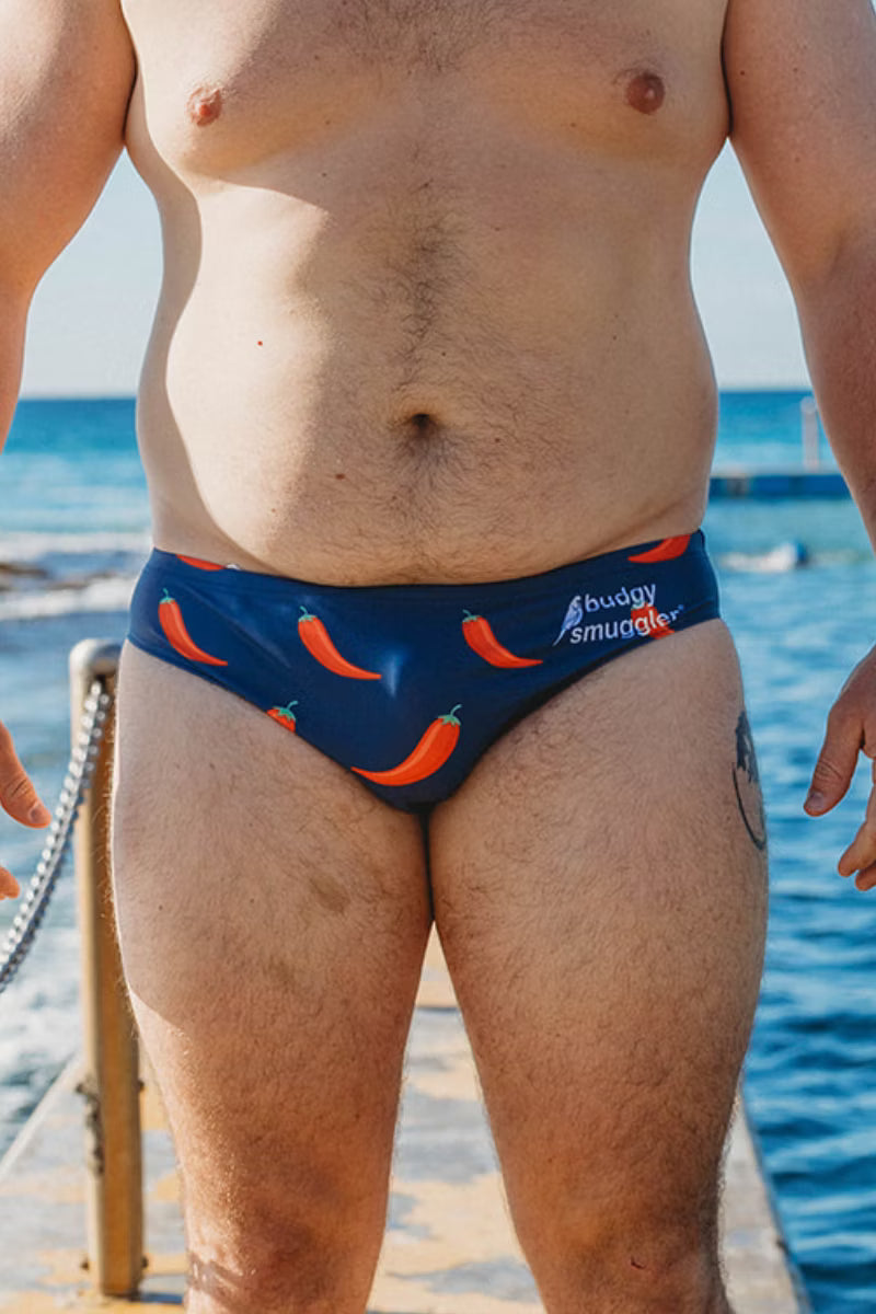 Front view of Chilli Willies navy men's swim briefs with red chilli print and Budgy Smuggler logo